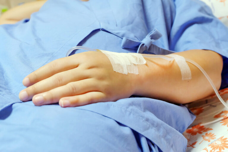 Saline intravenous (iv) drip in a women patient hand